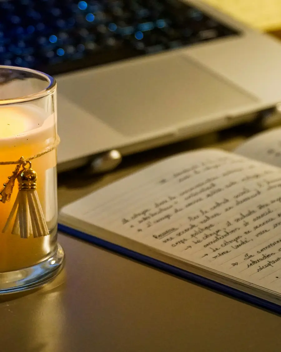Warm desk with candle and open notebook